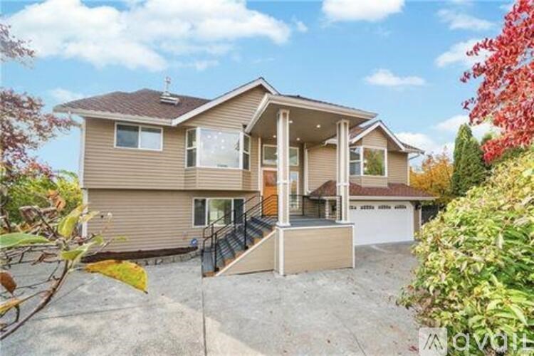 A two-story house with a garage and a driveway.