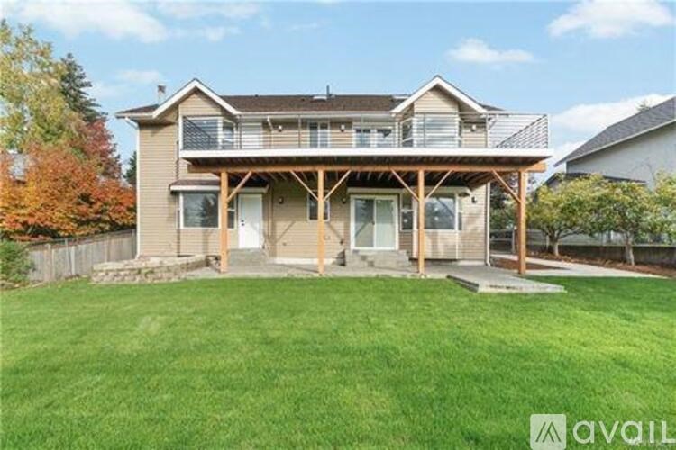 A house with a large front yard and a deck.