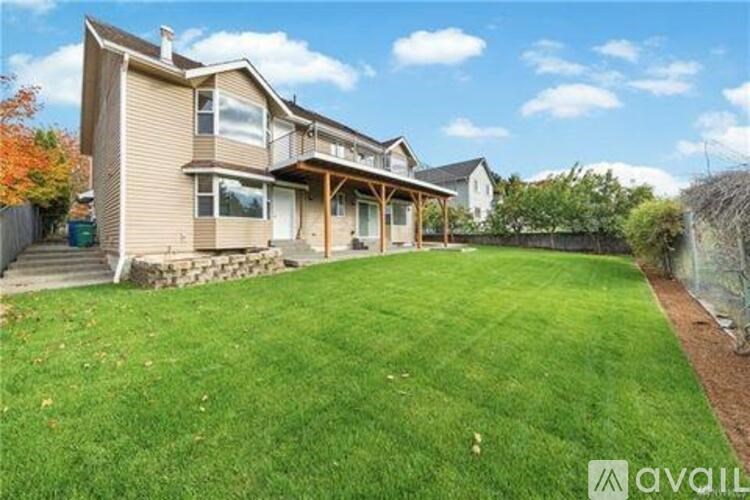 A house with a large lawn in front of it is for sale.
