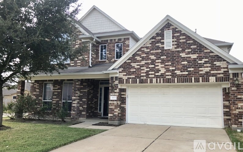 A house with a brick facade and a white garage door.