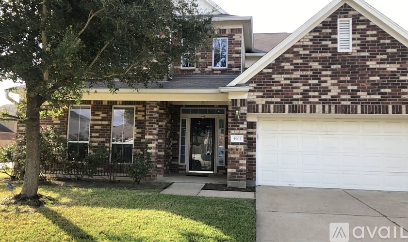 A house with a brick facade and a white garage door.