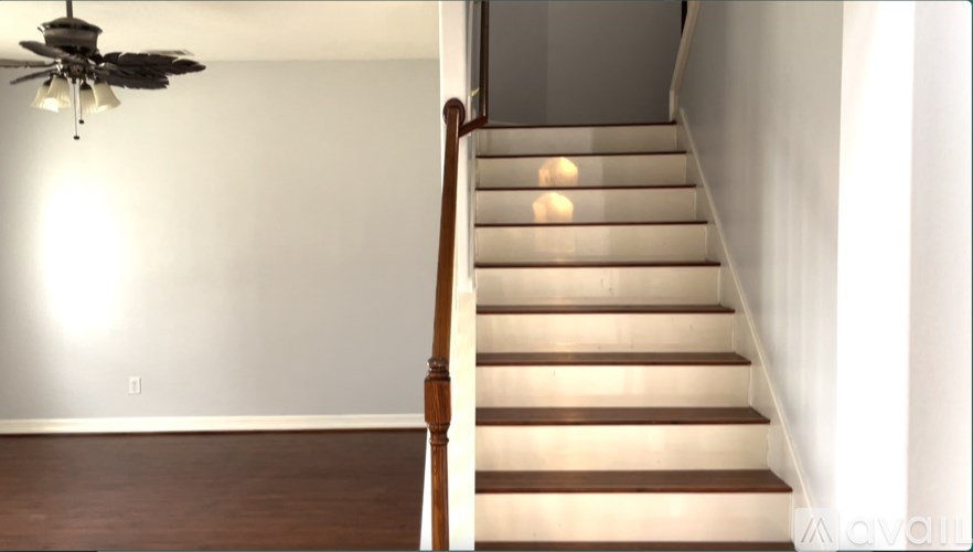 A staircase with a light on the side.