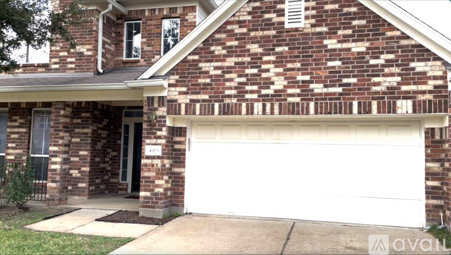 A brick house with a white garage door.