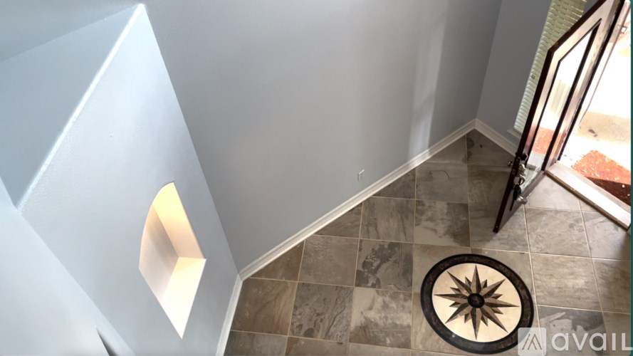 A tiled floor with a star design in the middle.