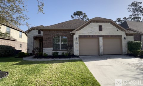 A house with a garage and a driveway in front.