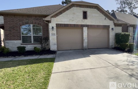 A house with a brown garage door and a white window.