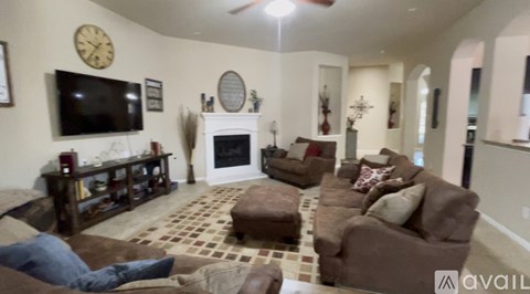 A living room with a fireplace and a television.