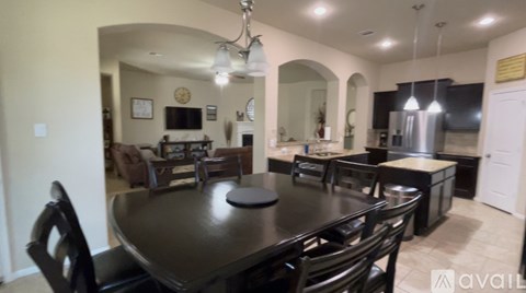 A dining room with a table set for six.