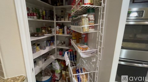 A white refrigerator is full of food and drinks.