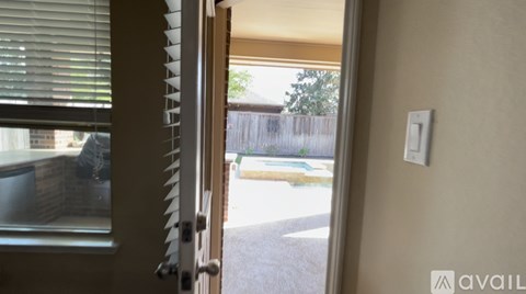 A white light switch is on a beige wall next to a door.