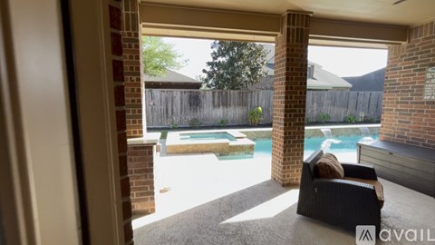 A patio with a pool and a couch.