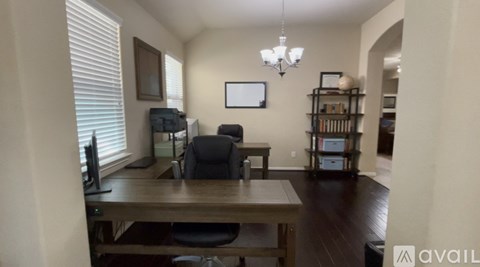 A room with a table, chairs, and a bookshelf.