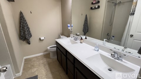 A bathroom with a white sink and a mirror.