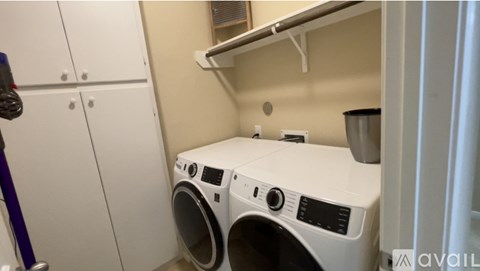 A small laundry room with a washer and dryer.