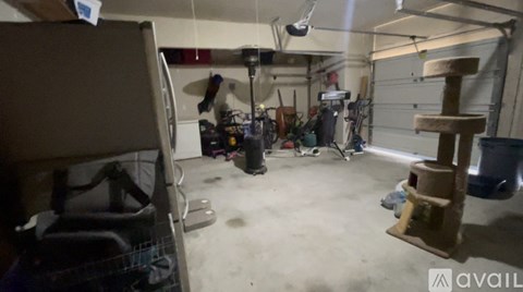 A cluttered garage with a variety of items scattered about.