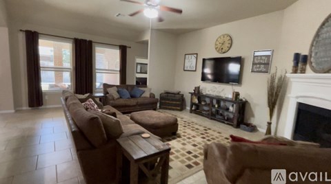 A living room with a fireplace and a television on the wall.