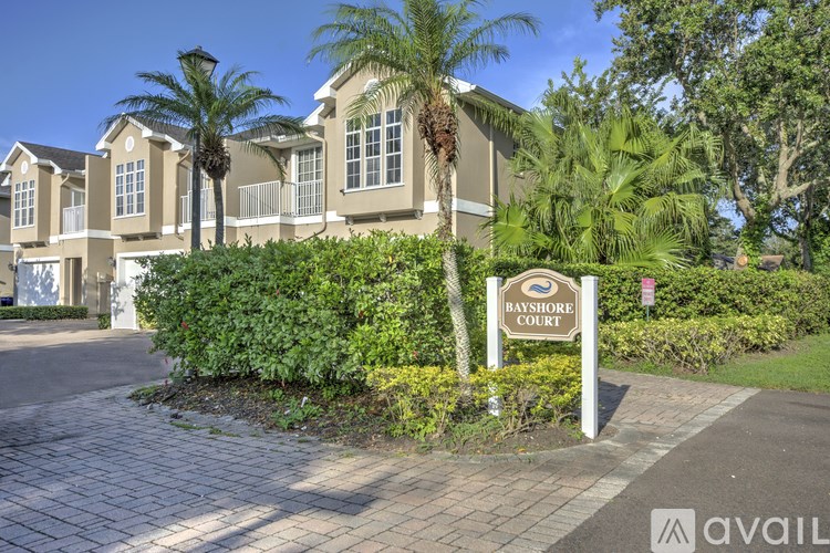 A sign that says Bayshore Court stands in front of a building.