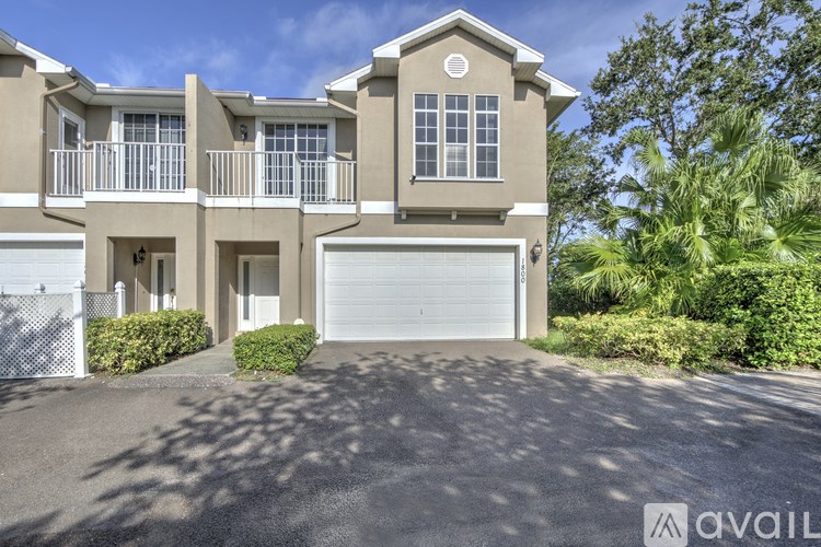 A two-story house with a garage is available for sale.
