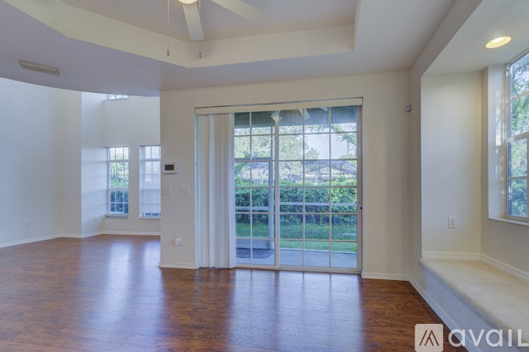 A room with a sliding glass door leading to a balcony.