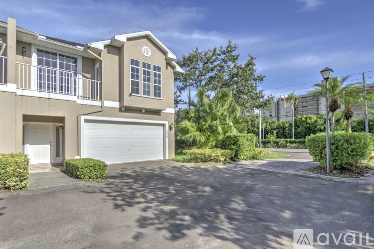 A two-story house with a garage is for sale.