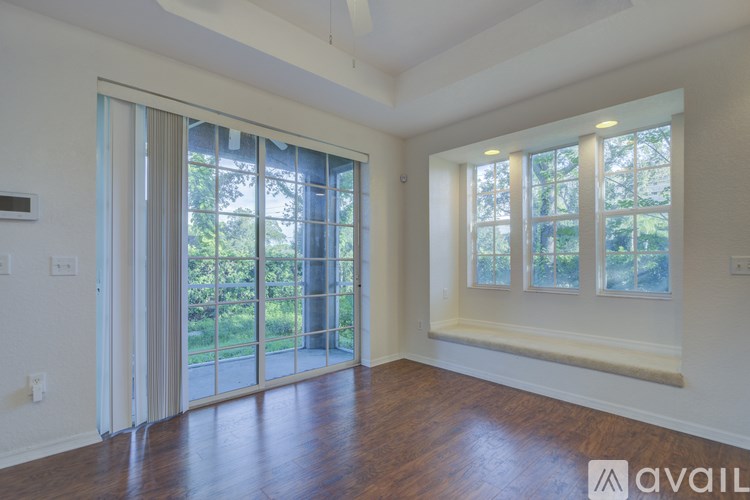 A room with a sliding glass door leading to a garden.