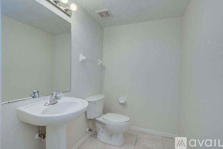 A white sink and toilet in a small bathroom.