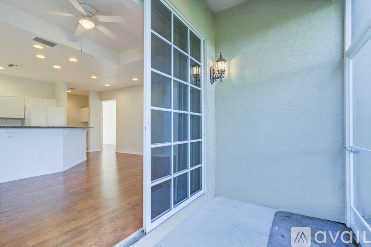 A room with a sliding glass door and a ceiling fan.