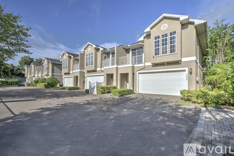 A large, two-story residential building with a driveway in front.