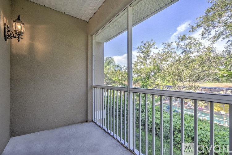 A balcony with a metal railing and a wall-mounted light fixture.