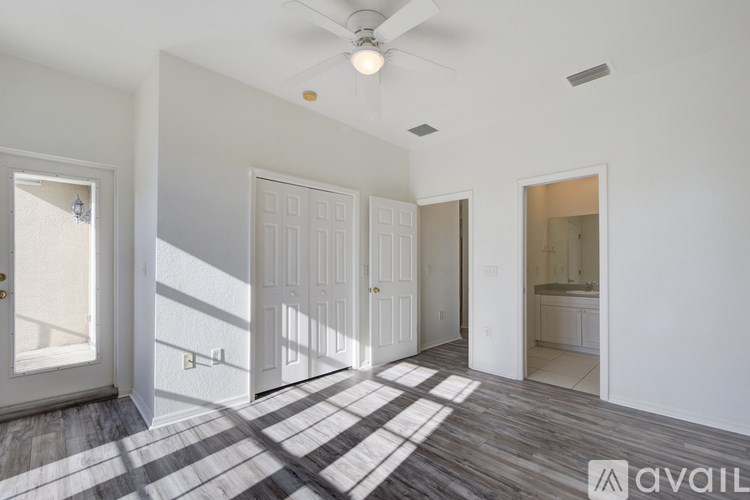 A room with a checkered floor and a ceiling fan.