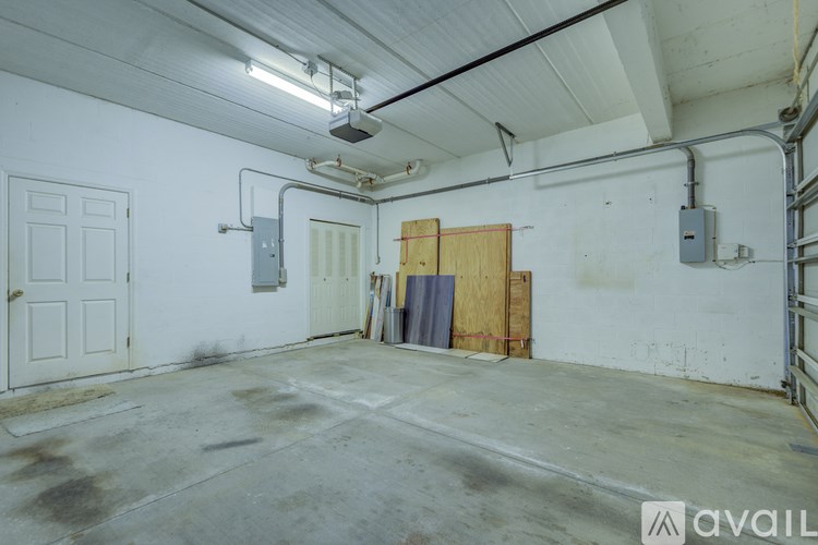 A large empty room with a door on the left and a door on the right.