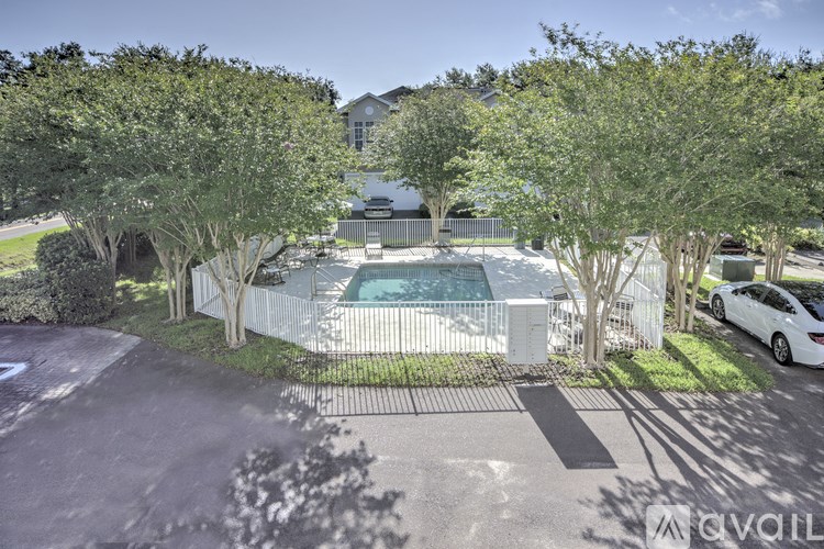 A white car is parked on the right side of the image.