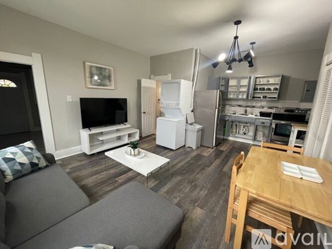 A living room with a grey couch and a wooden table.