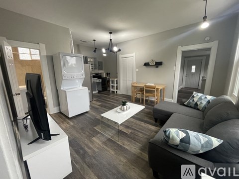 A living room with a grey couch and a white coffee table.