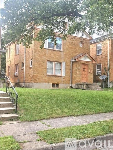 A brick building with a green lawn in front.
