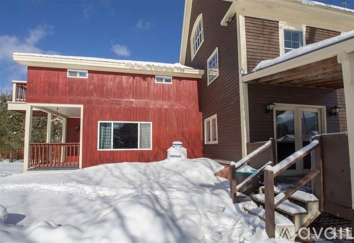 A red house with a brown house attached to it.