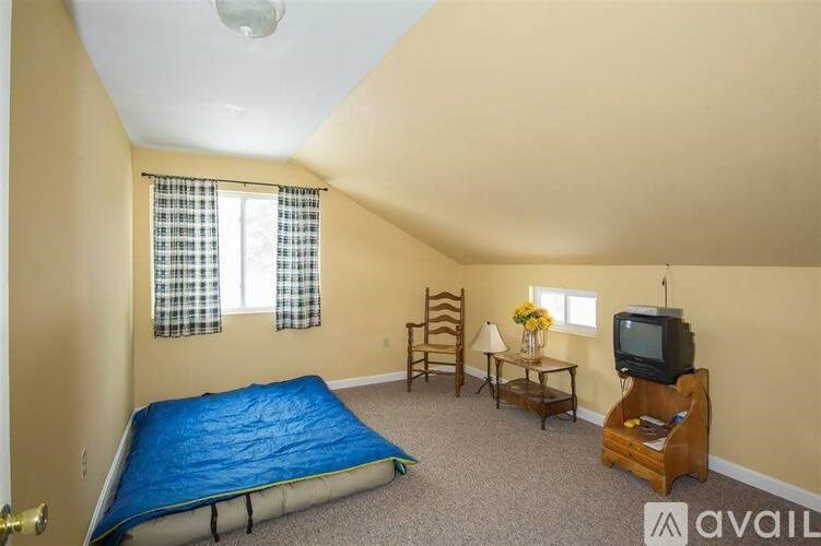 A bedroom with a blue mattress and a television.