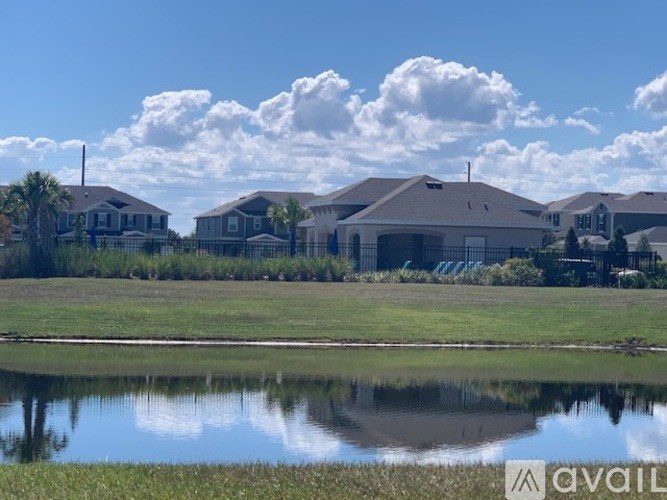 A row of houses with a body of water in front of them.