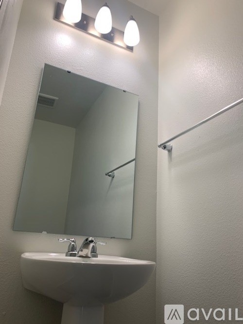 A bathroom with a sink and mirror.