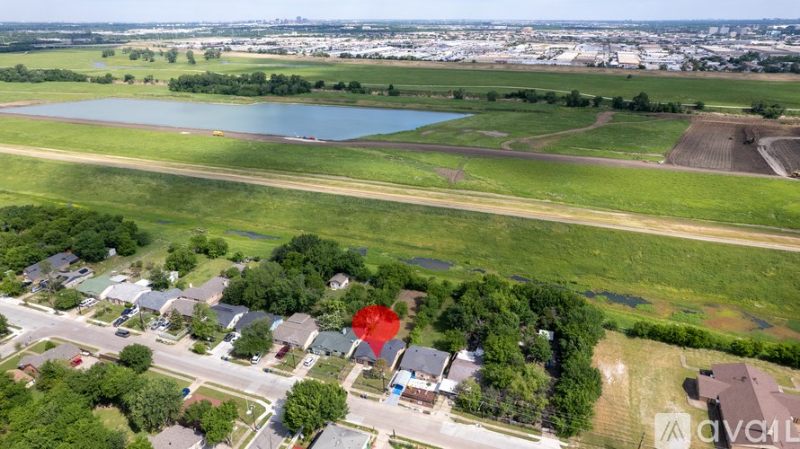 A red pin marks a house in a suburban neighborhood.