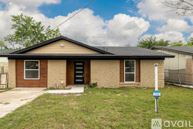 A house with a brown front door and a sign that says "available" in the front yard.