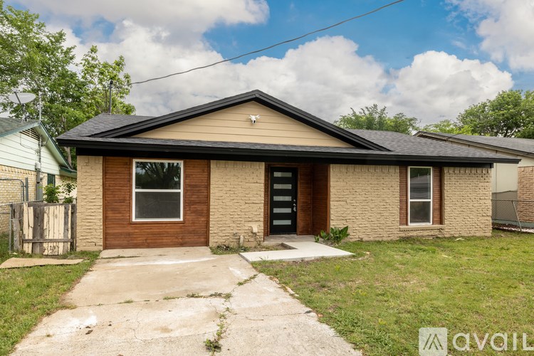 A house with a brown door and a brown roof.