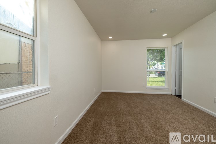 A room with a carpeted floor and a window.