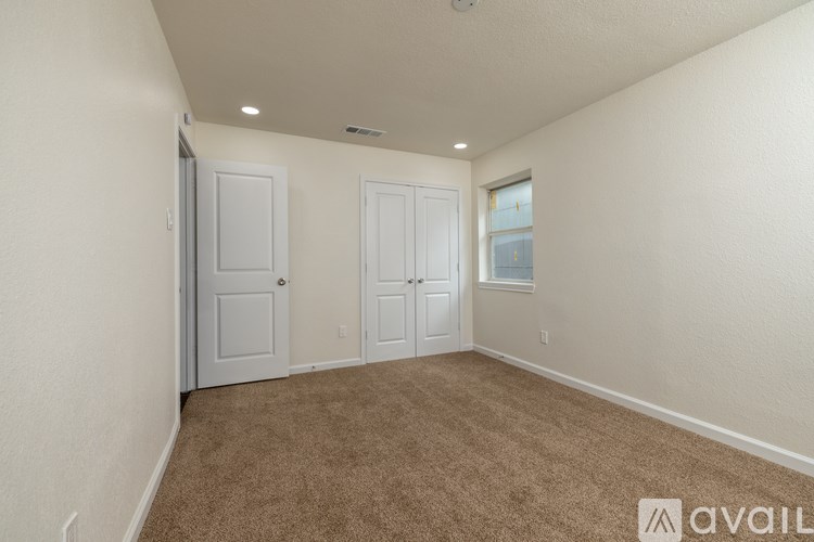 A room with two doors and a window.