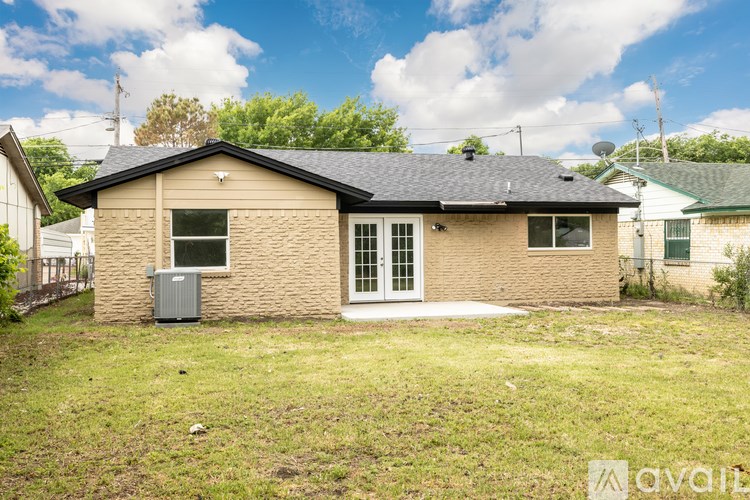 A small house with a brown brick exterior and a white door is for sale.