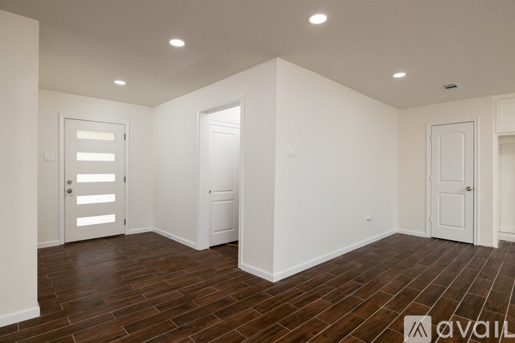 A room with wooden floors and white walls.
