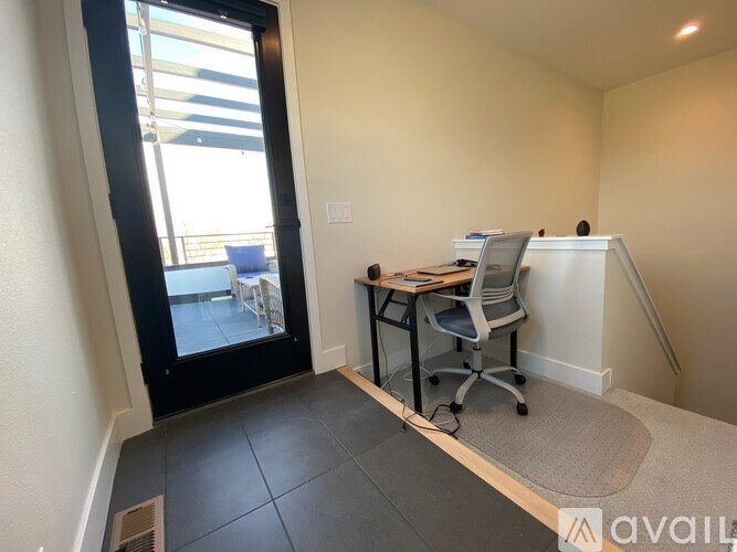 A room with a desk and chair in it.