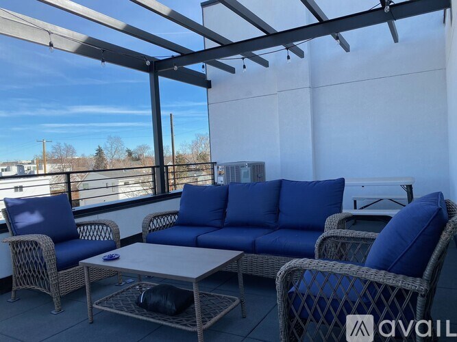 A patio furniture set with blue cushions is available for purchase.