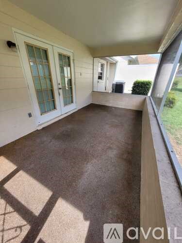 A patio area with a door and a window.
