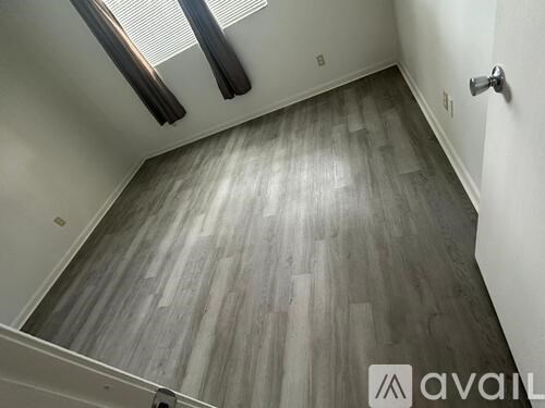 A room with wooden flooring and a skylight.